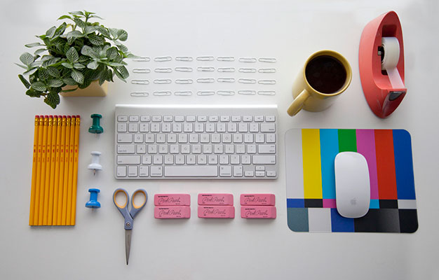 A clean and modern desk layout with a keyboard and various peripherals